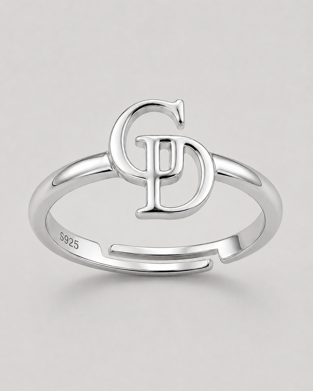 A sterling silver adjustable ring with a split band and a large interlocking 'CD' monogram design on top. The inside of the band is stamped with 'S925'.