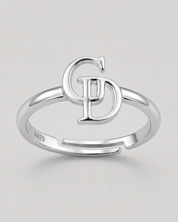 A sterling silver adjustable ring with a split band and a large interlocking 'CD' monogram design on top. The inside of the band is stamped with 'S925'.